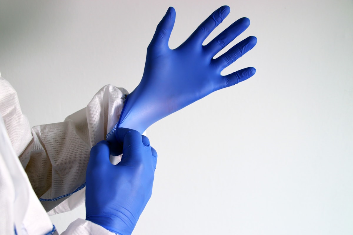 Worker wearing chemical-resistant gloves